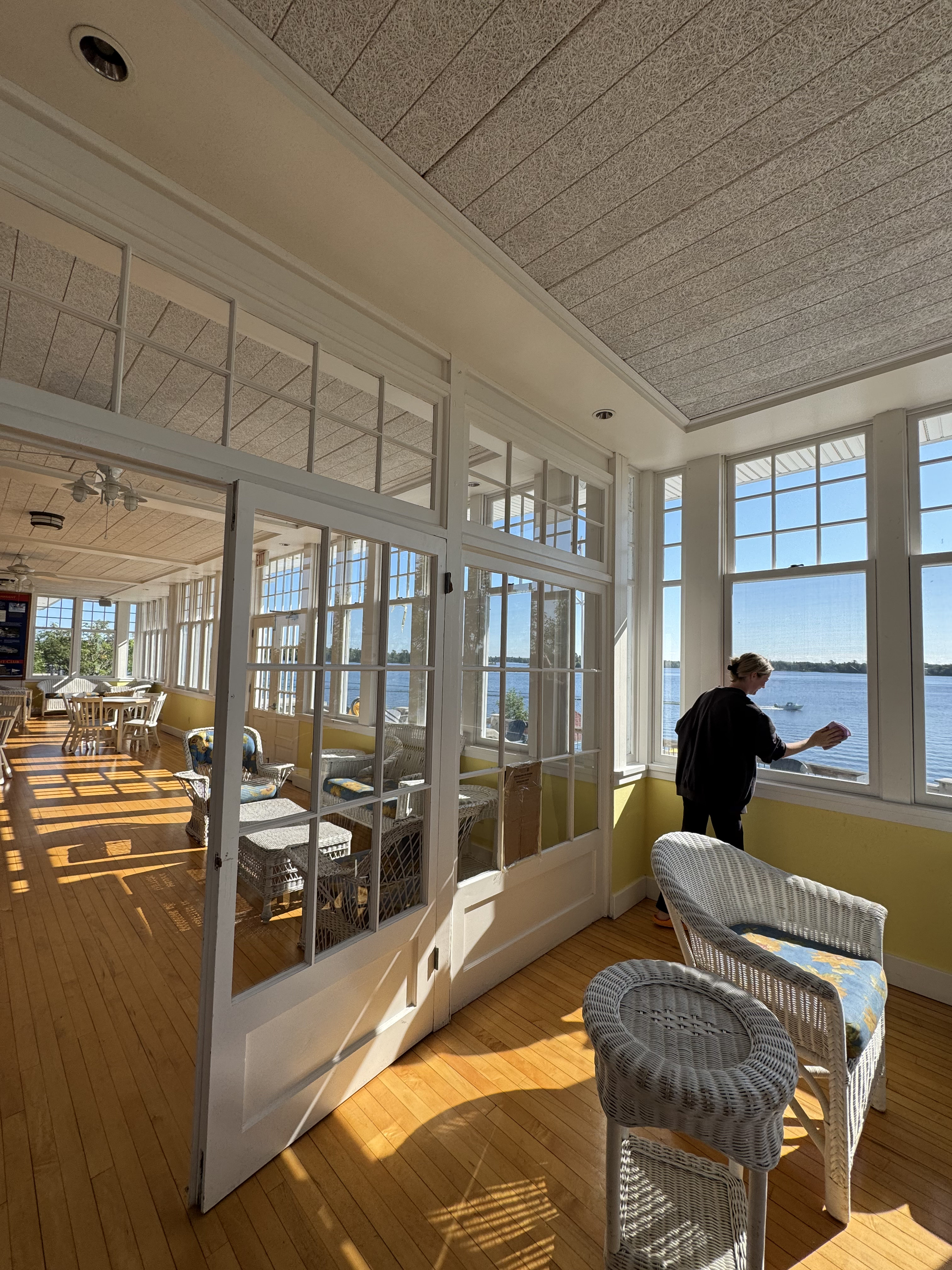 Cleaning a sunlit lake-facing sunroom on an island camp